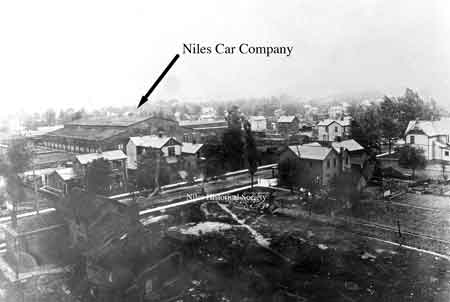 Photo of one building of the Niles Car & Manufacturing Co. taken from atop the water tower in the early 1900's. Mason Street is in the foreground. PO1.1429