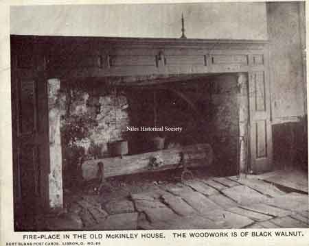 A postcard of the interior of the McKinley House showcasing the fireplace, surrounded with woodwork of black walnut.