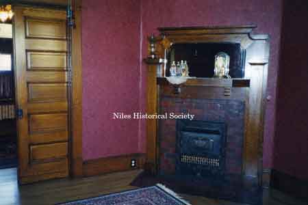 The downstairs feature solid oak pocket doors and a fireplace with oak mantel with a ceramic tile surround and hearth as was custom in this time period.