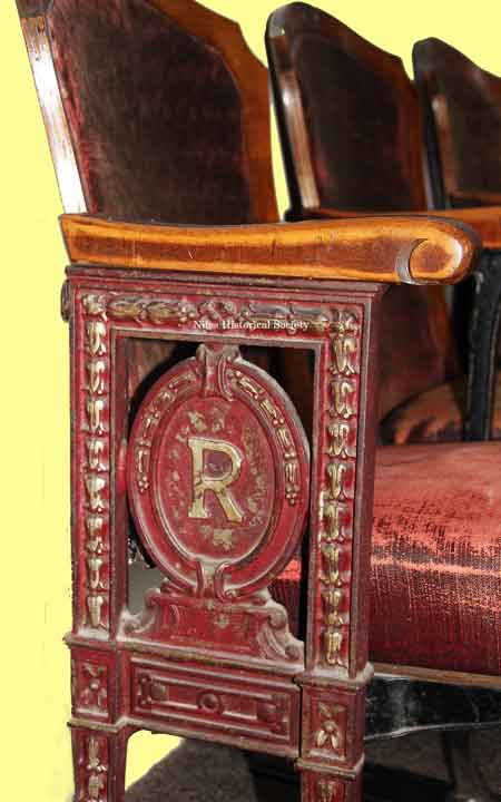Side view of Robins Theatre end seat with emblem of R for Robins.