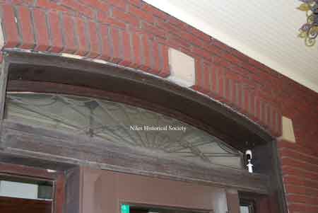 Arch over front entrance with cut glass.