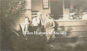 (R)William Blott and Carrie Anna Klingensmith Blott on front porch, 1930s.