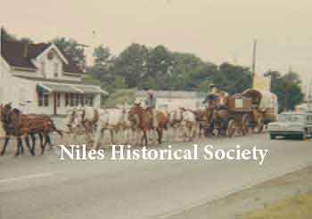Parade of conestoga wagons on the move in front of the Carlisle home and the restaurant eatery across Niles-Vienna Road.