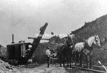 Horses and steam shovel excavating the underpass
