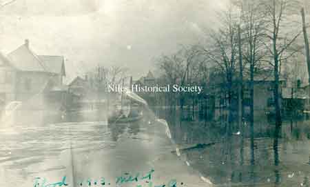 A postcard photo from the 1913 flood, showing Mill Street (now West State Street). The Flory Boarding House is located in the center rear at the corner of Chestnut and State.