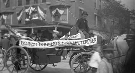 President William McKinley's first grade teacher, Miss Sanford, is seen riding in this carriage during a parade on North Main Street and Park Avenue.