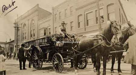 View of a horsedrawn fire engine standing on State Street.
