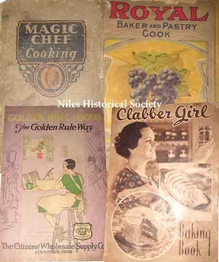 Covers of various cookbooks on display in the 1920s kitchen display at The Ward-Thomas Museum.
