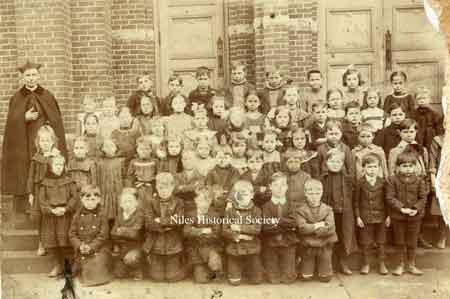 Unidentified St. Stephen's priest and pupils pose in this photo ca 1900.
