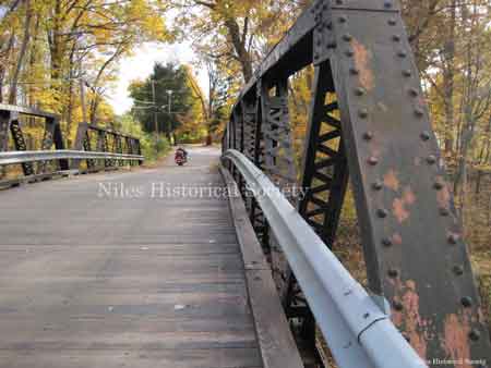 The Fifth Avenue Iron Bridge with its wooden roadway provided access over the Pennsylvania Railroad tracks that followed the Mahoning River.