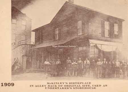 The photograph shows the section moved to Franklin Alley where it became a storehouse for an undertaker. Later, the Harris Offset Printing Company would occupy this building.