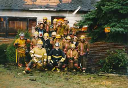 The 1994 M.M.B.A. Volunteer fire department poses in front of house they were called to extinguish the flames.