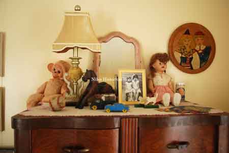 Nursery detail: Auburn Rubber Co. toy cars; silver-plated rosary cases (from the estate of Gay Krok); Ideal Toy “Saucy Walker” doll. The portrait of two former Little House residents was taken by Louis Pela, Sr. in 1934.