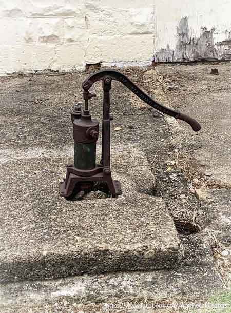 Red Cross cast iron well pump, capping a well used before the Little House had indoor plumbing.