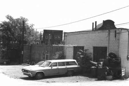 Side view of Sammy Bernard's Arco gas station located on Pine Alley before urban renewal. 