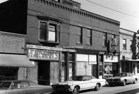 Photo of building located at 85 East State Street in down town Niles before urban renewal. Bernard Music is located in right hand corner of picture.