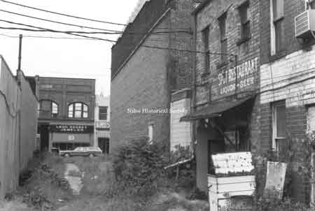 Photograph dated June 11, 1972 taken of the west side of Doubet's Jewelry Store. This is oldest (1987) of the original stores left in town