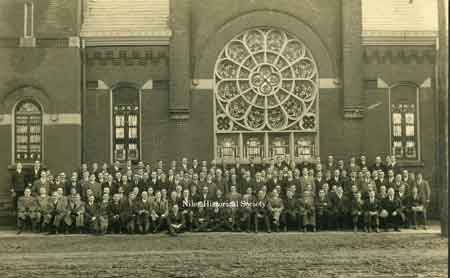 The Men’s Bible Class of First Christian Church on the lawn in front of the church. The stain glass rosette window of the First Christian Church on Arlington Street.