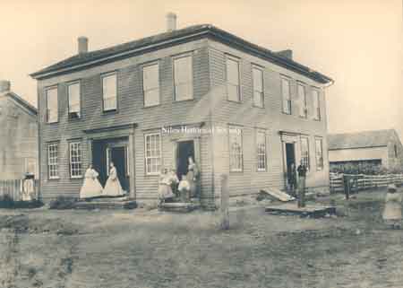 The southwest corner was built as a hotel in 1842 and purchased by the Harris Family in 1865 who occupied it until 1904. From then until 1920, it was used as a store and warehouse.