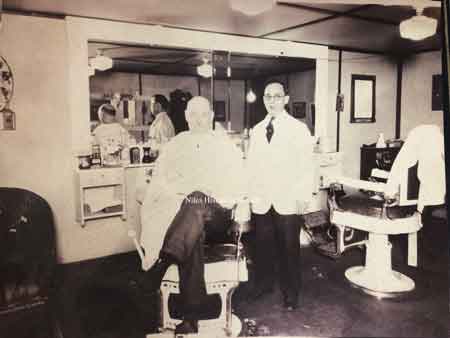 Pictured in the barbershop on the lower level of Elder’s Drugstore is Phil Melillo and unknown customer.