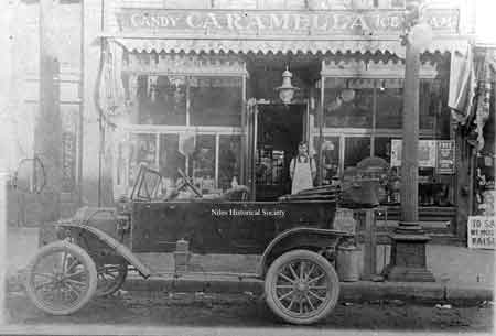 Photo taken outside Caramella’s Confectionary Shop in 1906 after it had been recently remodeled.