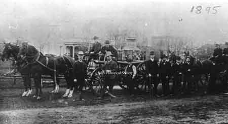 1895 photograph of the Niles fire department apparatus with the city building in the background.