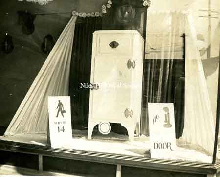 Picture of a store display window featuring a modern refrigerator for Rice Electric, 1931.