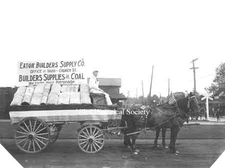 A photo of a float from the 1909 Homecoming parade. Eaton Builders Supply, located on Church Street.