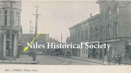 A view of Mill Street looking east from Main Street. Mill and Furnace Streets were combined into State Street. The yellow arrow indicates the approximate location of the old library.