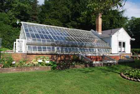 Attached to the rear of the garden shed is the green house