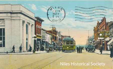 This postcard, dated August 19, 1927, shows the Dollar Bank building and several brick buildings that were built before 1900 on the east side of South Main Street.