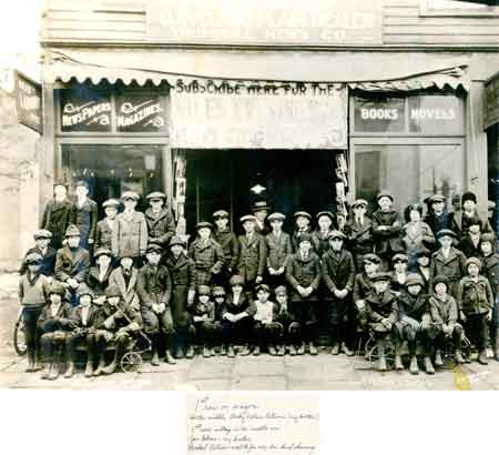 November 19, 1922, newspaper delivery boys in front of the newsstand on Main Street with manager William Klatt.