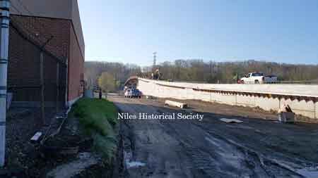 The final photos show the demolition in October 2014 and the new steel beams being placed in March 2015.