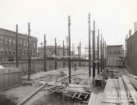 A series of photographs documenting the various stages of the construction of the Niles Trust Company Building.