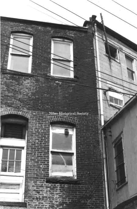 Photo taken of rear facade of unidentified building located on the east side of East State Street (over Mosquito Creek) in downtown Niles before urban renewal.
