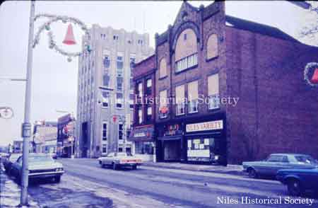 View of the IOOF Building and Calvin's Drug Store at corner of North Main Street and West Park Avenue. All buildings at this corner have been demolished.