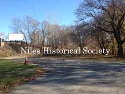 The site is now only trees and the pavement is remnants of the old Church Street entrance to Robbins Avenue